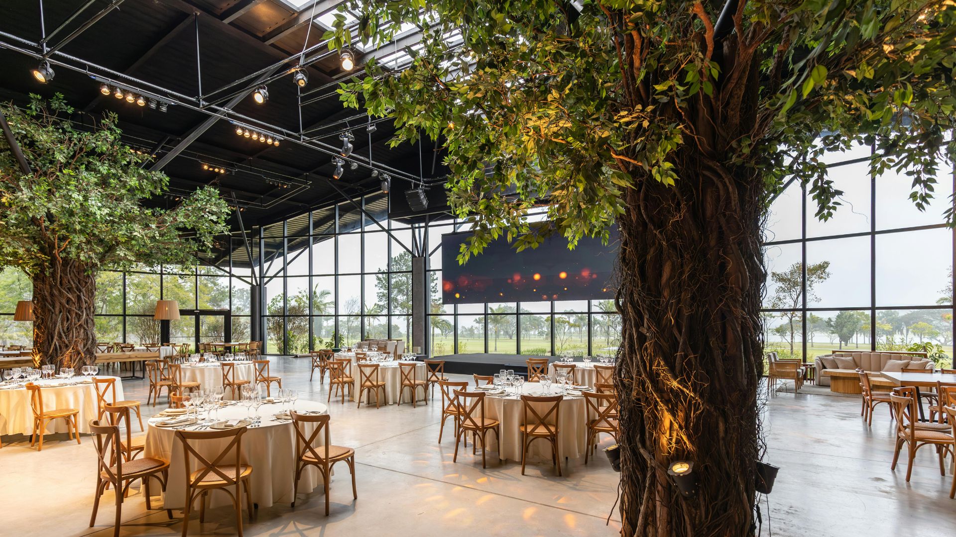 Event venue setup with tables and greenery interior, promoting curated venue sourcing instead of searching online